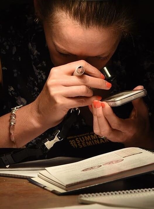 WOMAN STUDYING COIN - Copy